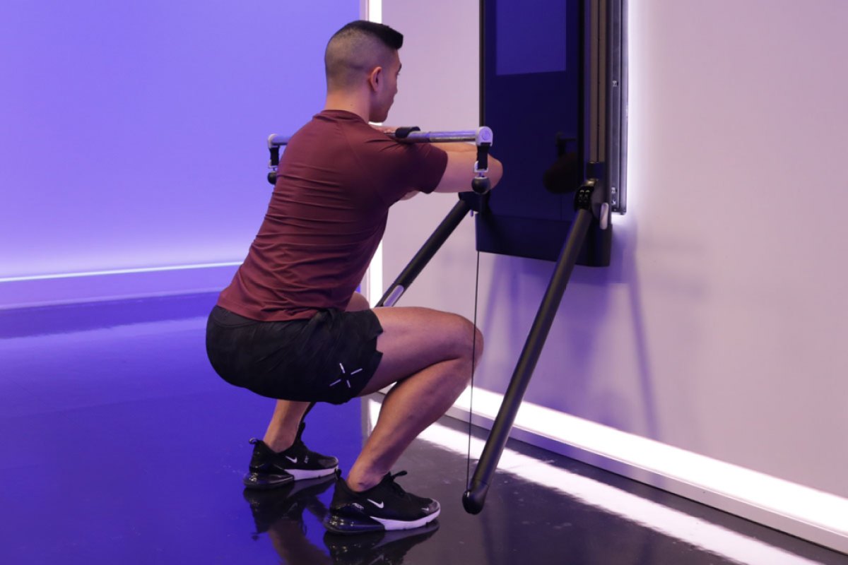 Tonal coach Tim Landicho doing a front squat on Tonal