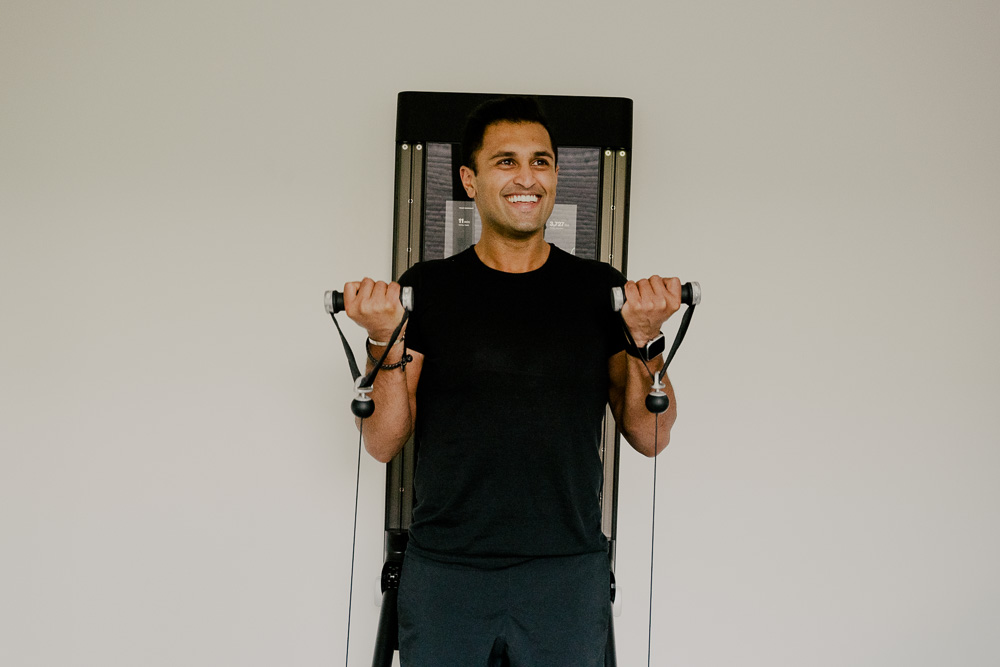 man working out on his Tonal smiling 